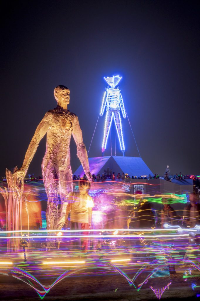 Huge Sculpture of a man next to the Man at Burning Man